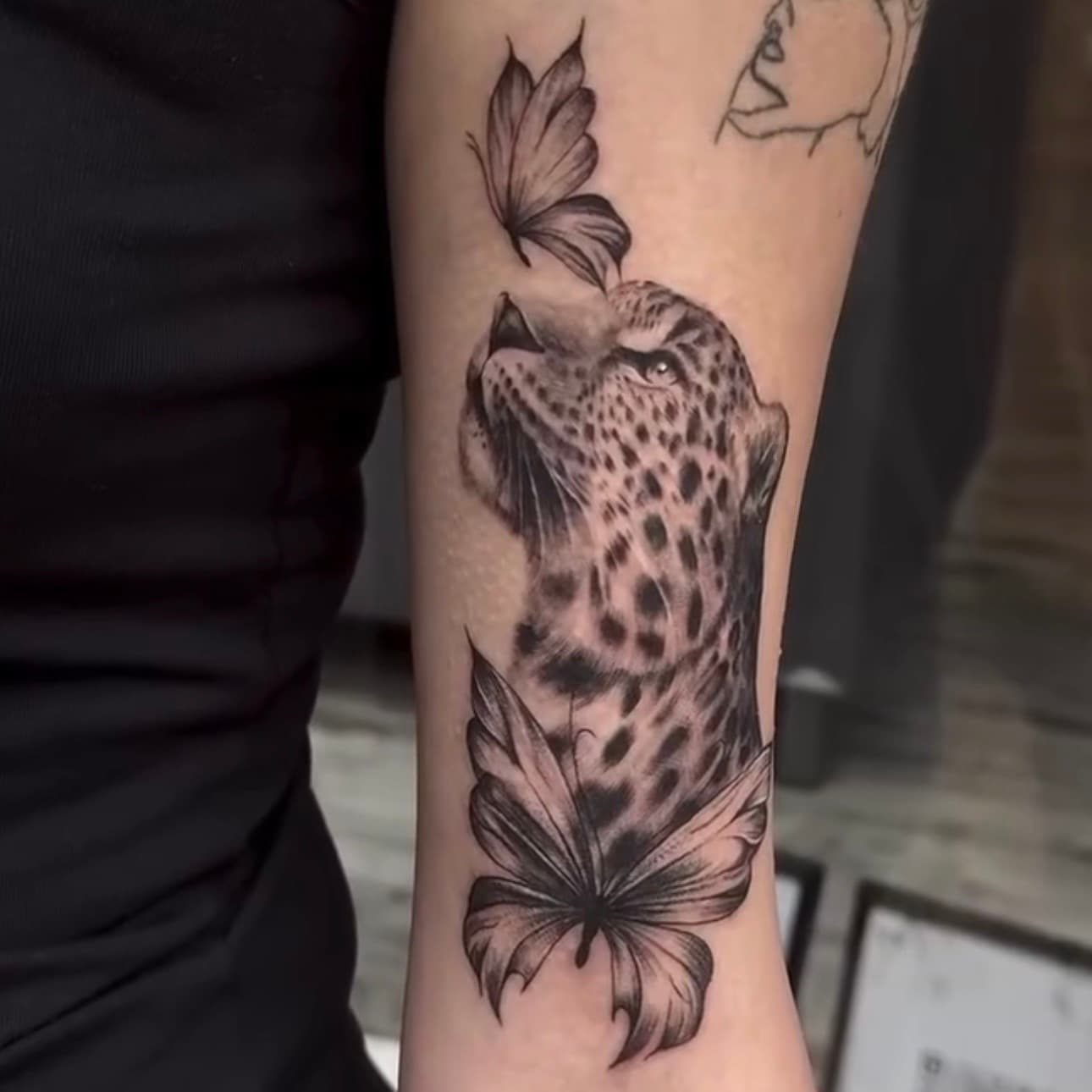 Realism leopard tattoo with fineline butterflies