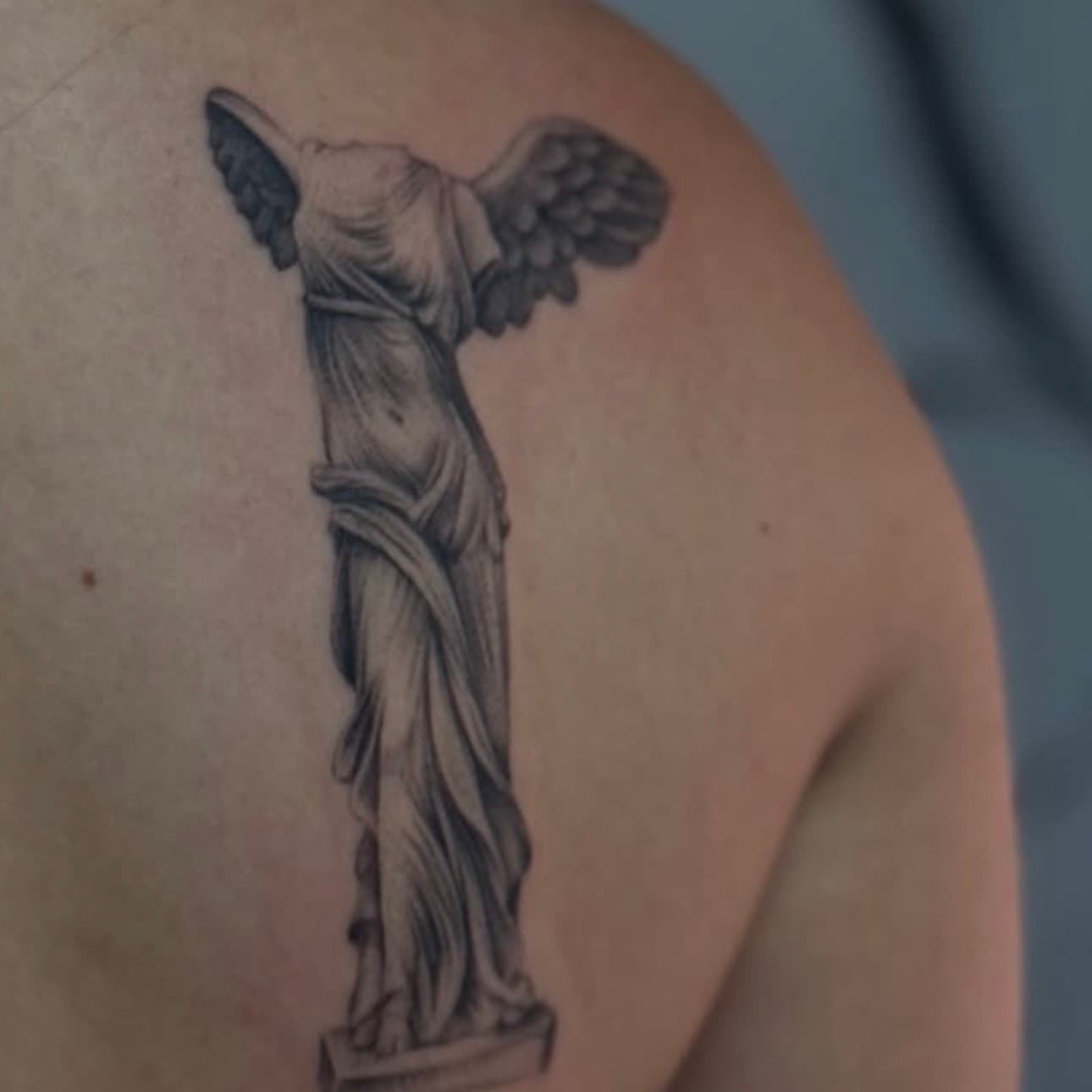 Winged Victory of Samothrace tattoo on the back