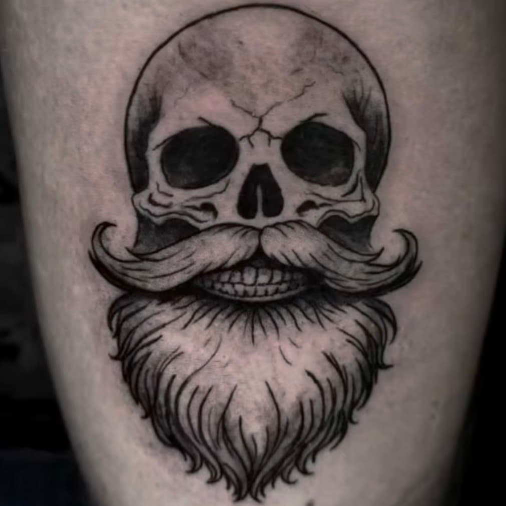 Traditional blackwork skull with beard tattoo, by Samuel