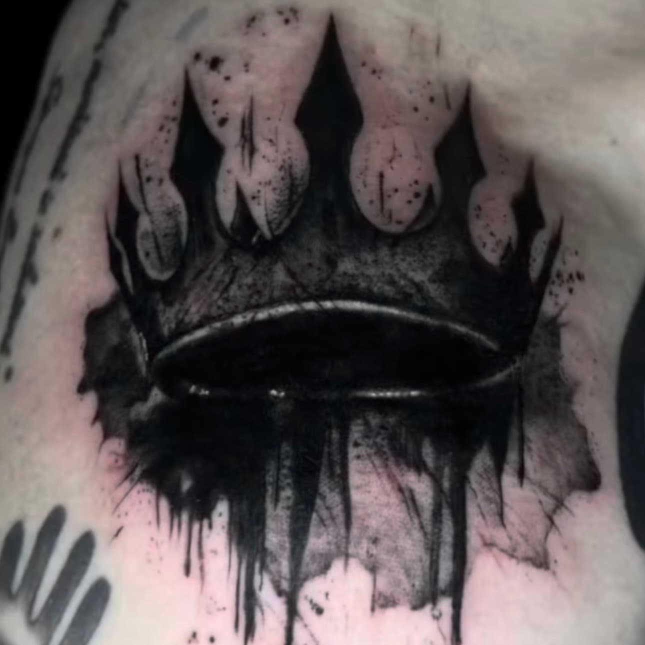 Blackwork crown with drip effect tattoo, by Samuel