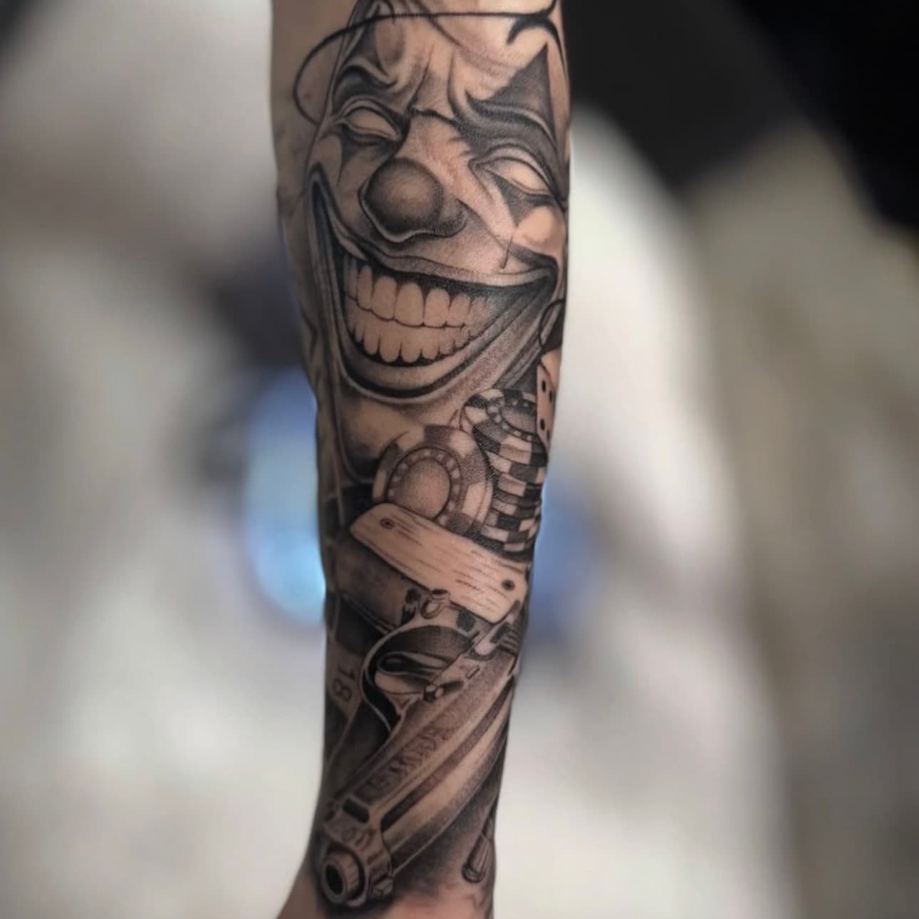 Realism clown with casino chips tattoo, by Sara